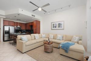 a living room with a couch and a kitchen at Prestigious Luxury Beach & Bay Patios XL Size in South Padre Island