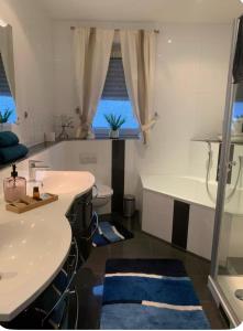 a bathroom with a tub and a sink and a bath tub at Black Forest Oase in Gaggenau +16 photos
