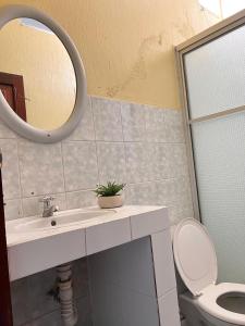 a bathroom with a sink and a toilet and a mirror at Hotel Hernandez in Chiquimula +23 photos