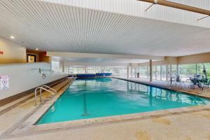 a large swimming pool with blue water in a building at Simba Run 2305 in Vail