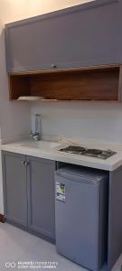 a kitchen with a counter top and a stove at Asdan Hotel in Al Ahsa