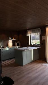 a kitchen with a island in the middle of a room at Steineveien 300 in Vestvågøya