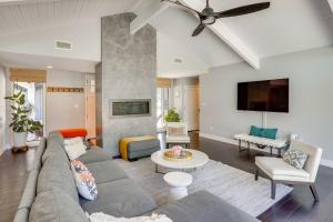 a living room with a couch and a ceiling fan at Mid Century Modern Gem with Pool in North Tustin in La Paloma