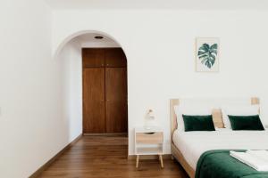 a white bedroom with two beds and a table at Quinta das Laranjeiras in Marinhais +155 photos