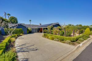 a house with a driveway in front of it at Mid Century Modern Gem with Pool in North Tustin in La Paloma