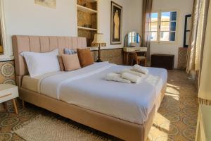 a bedroom with a large bed with towels on it at Dar Mima rooftop sea view in Sidi Bou Saïd