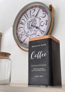 a book sitting on a shelf next to a clock at Villa Paradis à 100m de la plage in Flic-en-Flac