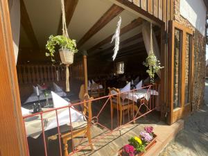 a balcony of a restaurant with chairs and plants at Landgasthaus Zum Engel in Neuleiningen