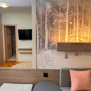 a living room with a painting on the wall at Vila Danica in Jahorina