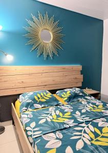 a bedroom with a bed and a mirror on the wall at Smylie home in Fort-de-France
