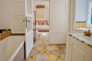 a bathroom with a tub and a sink at Dar Mima rooftop sea view in Sidi Bou Saïd