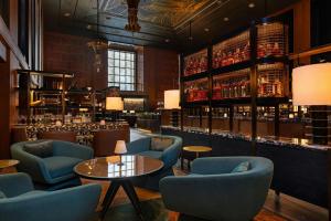 a bar with blue chairs and a table at The Westin Minneapolis in Minneapolis