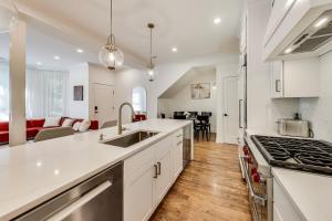 a kitchen with white cabinets and a living room at Luxurious Lincoln Park Home with Gourmet Kitchen in Chicago