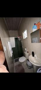 a bathroom with a shower and a toilet and a sink at Alugo Casa COP30 em Belém no distrito de icoaraci in Belém