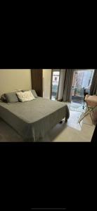 a bedroom with a bed and a window and a chair at Alugo Casa COP30 em Belém no distrito de icoaraci in Belém