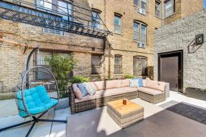 a patio with a couch and a chair and a building at Luxurious Lincoln Park Home with Gourmet Kitchen in Chicago