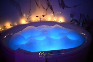 a blue bath tub with lights in a room at Carpe Diem Spa Apartman in Teslić