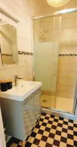a bathroom with a sink and a shower at REPOS 150m plage Coeur de Berck in Berck-Plage