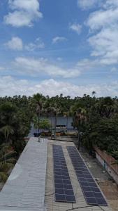 a row of solar panels on a boardwalk with trees at viladowalbinhobarreirinhas in Barreirinhas