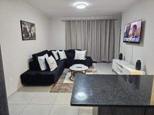 a living room with a couch and a table at Eland Ridge in Boksburg