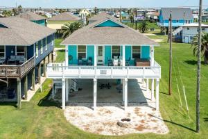 an aerial view of a blue house with a porch at Across from Jetty Park and Best Ship Watching in Surfside