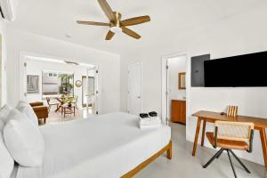 a white living room with a bed and a table at Sleek Kitchenette & Queen Bed in Fort Lauderdale