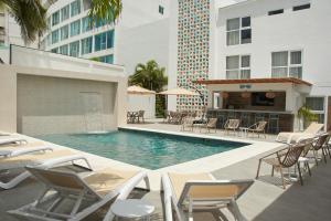 a pool with chairs and a bar in a building at Zafi Hotel in San Andrés