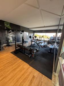 a gym with several treadmills and machines in a room at Casa Arruda Climatizada 5 proximo shopping boulevard in Vitória da Conquista +18 photos