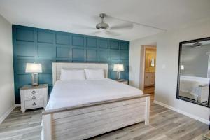 a bedroom with a large bed and a mirror at El Matador 430 - Third floor unit in Fort Walton Beach +24 photos