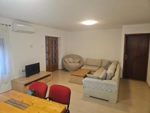 a living room with a couch and a table at Apartman Dinja in Posušje