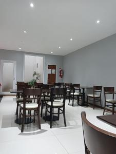 a dining room with wooden tables and chairs at Hotel Neptuno in Mar del Plata