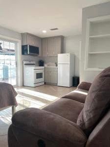 een woonkamer met een bank en een keuken bij 海湾景观休闲独立屋可垂钓靠近达利博物馆 in St Petersburg