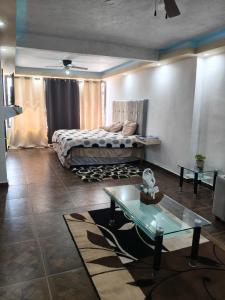 a bedroom with a bed and a table in it at Finca Chapis in San Sebastian Xolalpa