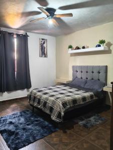 a bedroom with a bed and a ceiling fan at Finca Chapis in San Sebastian Xolalpa