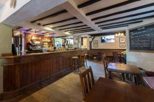 a restaurant with a bar and tables and chairs at The bucks head in Church Stretton