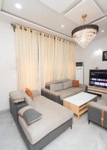 a living room with a couch and a tv at Tranquil 5BR Duplex in Lekki in Maiyegun