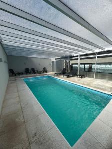 a large swimming pool in a building at Parry Smart Hotel in Puerto Madryn