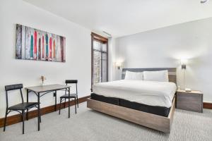 a bedroom with a bed and a table and chairs at Arrowleaf Lodge - 1 Bed Studio #100A in Park City
