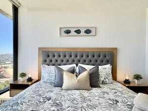 a bedroom with a large bed with pillows at Cosmopolitan TJ - Costco and San Ysidro Border USA in Tijuana