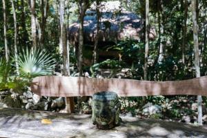 a park bench with a statue in front of it at Cavelands become one with nature in Cedro