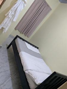 a small bed in a room with a window at Masaka Haven in Masaka
