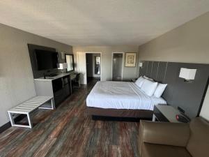 a hotel room with a bed and a couch at Anderson Inn in Anderson