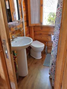 a bathroom with a white sink and a toilet at Etna Baite Milo in Milo +28 photos