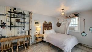 a bedroom with a white bed and a window at Rosewood Collective by WanderLodges - Hot tub -Sauna in Medford