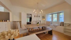 a kitchen and dining room with a table and chairs at Rosewood Collective by WanderLodges - Hot tub -Sauna in Medford