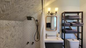 a bathroom with a shower and a sink at Rosewood Collective by WanderLodges - Hot tub -Sauna in Medford +24 photos