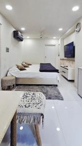 a bedroom with two beds and a tv on the wall at Shanti Niwas Jodhpur, Rajasthan in Jodhpur +10 photos