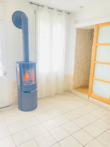 a fireplace in a room with a tile floor at Maison Individuelle Tout Confort Terrasse Extérieur Proche Parc Asterix, Aéroport Roissy CDG, Paris, Disney, Château de Chantilly in La Chapelle-en-Serval