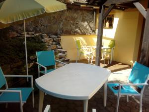 a table and chairs and an umbrella in a room at Villa Wurzer in Velden am Wörthersee