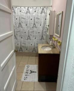 a bathroom with a sink and a shower curtain at Hostel Gloria Viña in Viña del Mar +40 photos